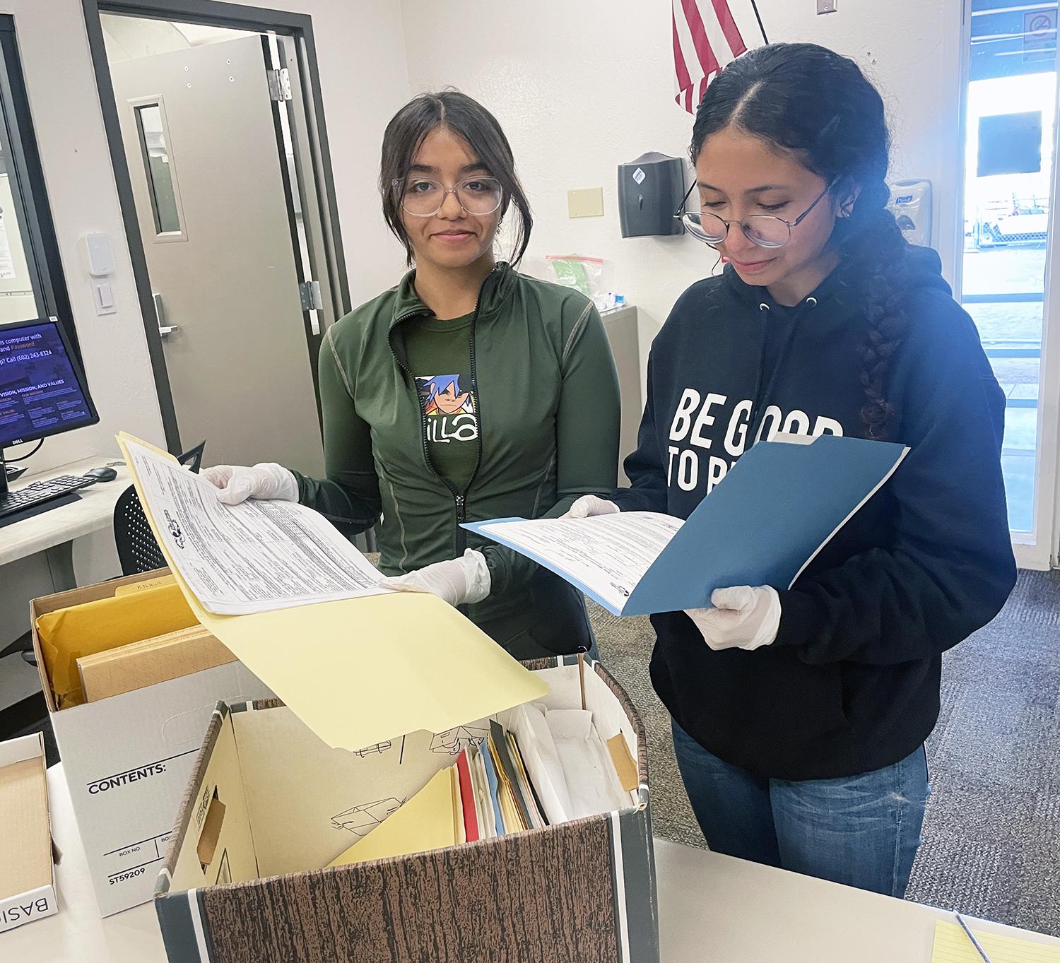 Students looking through boxes